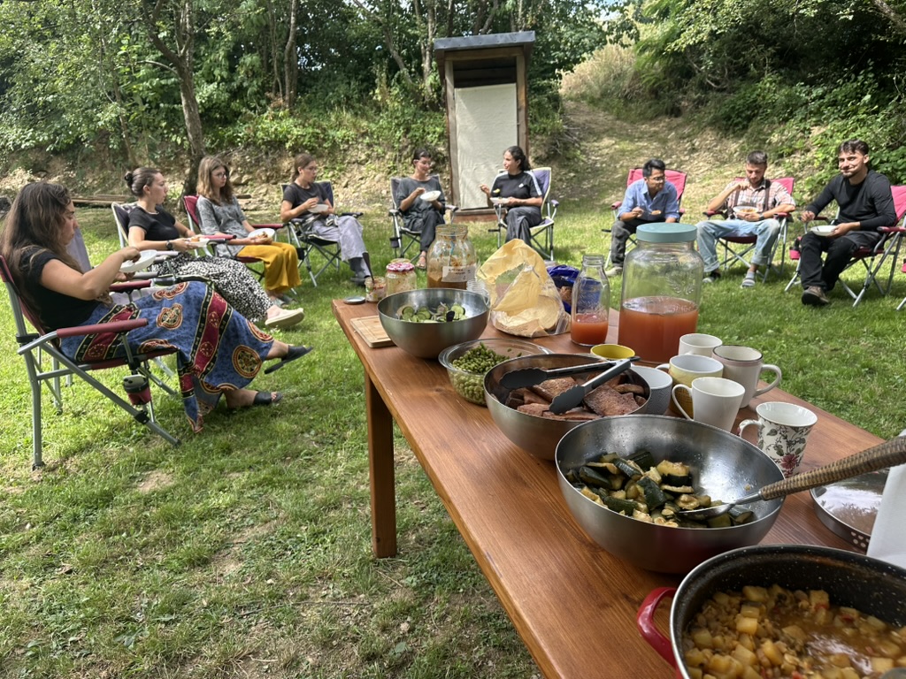 Friends sharing a potluck lunch in the garden.